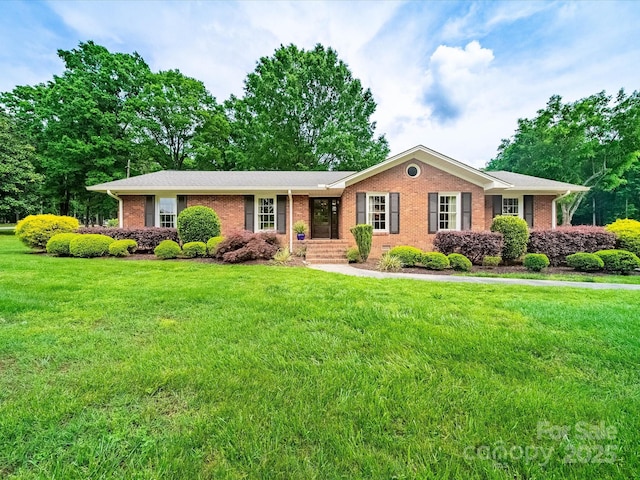 ranch-style house with a front lawn and brick siding