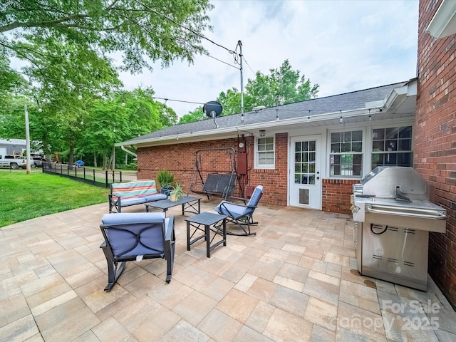 view of patio featuring fence and area for grilling