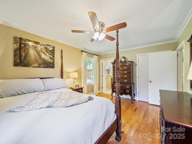 bedroom with ornamental molding, ceiling fan, and light wood-style flooring