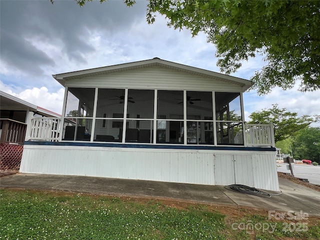 view of home's exterior with ceiling fan and a sunroom