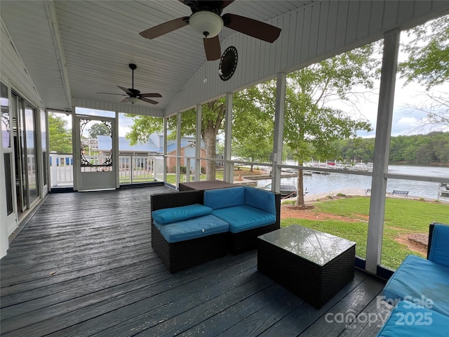 deck with a lawn, a ceiling fan, and a water view