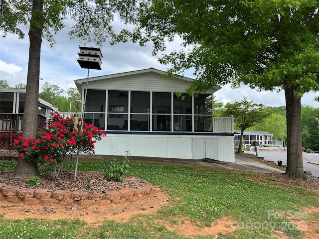 back of property with a sunroom