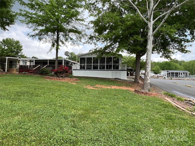 view of yard featuring a sunroom