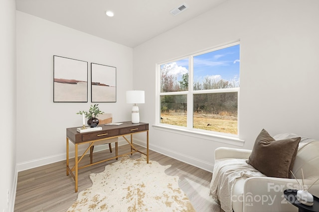 office space featuring baseboards, visible vents, light wood-style flooring, and recessed lighting