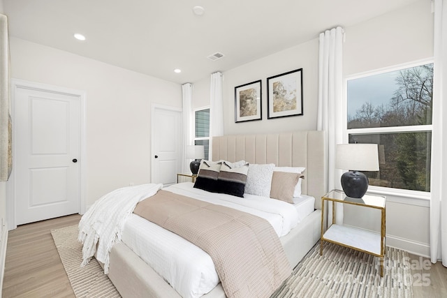bedroom featuring visible vents, recessed lighting, and light wood finished floors