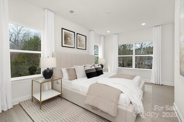 bedroom featuring recessed lighting, visible vents, wood finished floors, and baseboards