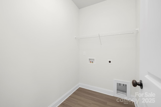 washroom with hookup for a washing machine, wood finished floors, laundry area, hookup for an electric dryer, and baseboards