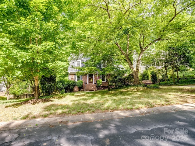 obstructed view of property featuring brick siding