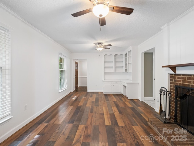 unfurnished living room featuring crown molding, a textured ceiling, a ceiling fan, dark wood-style flooring, and a fireplace
