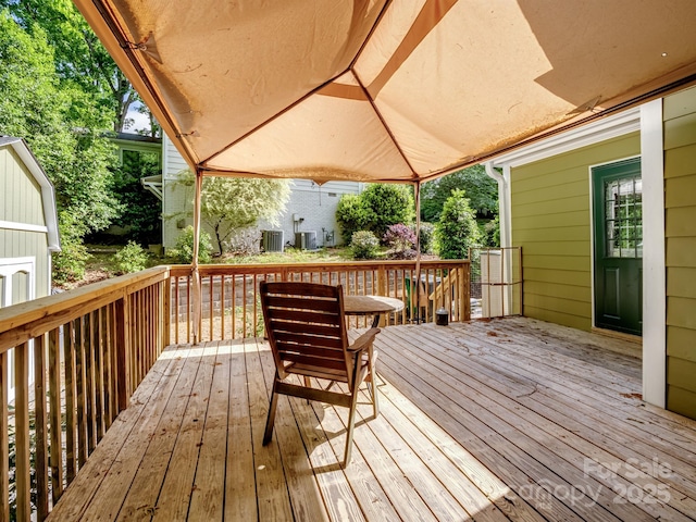 wooden deck featuring central AC unit