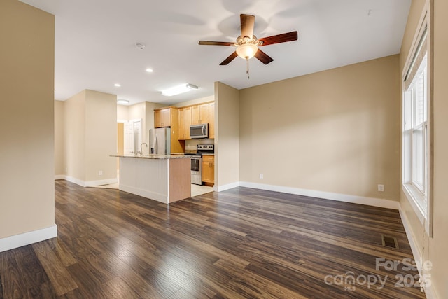 unfurnished living room with a ceiling fan, baseboards, recessed lighting, visible vents, and dark wood-style floors
