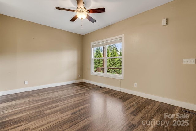 spare room with a ceiling fan, baseboards, visible vents, and wood finished floors