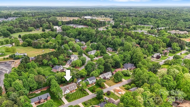 aerial view featuring a residential view and a wooded view