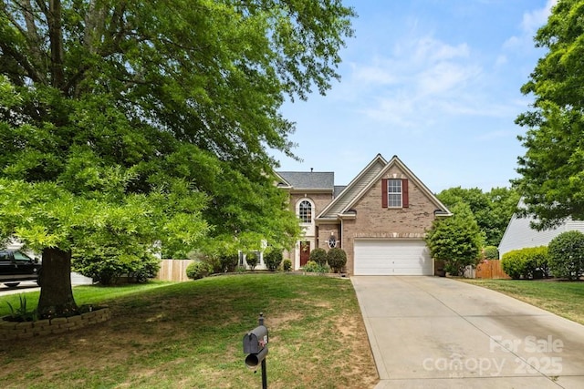 view of front of house with driveway, a front yard, fence, brick siding, and a garage