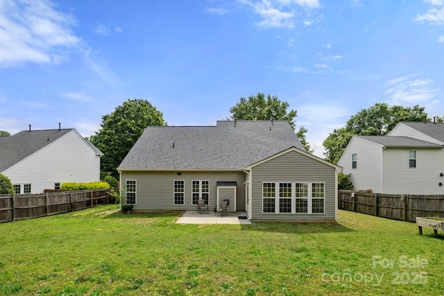 rear view of house featuring a yard, a fenced backyard, and a patio area