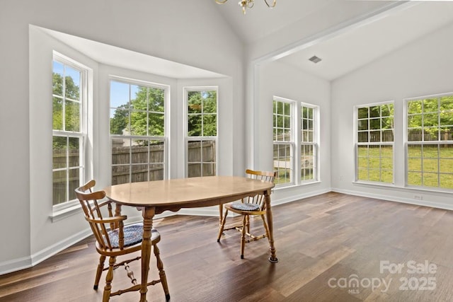 sunroom / solarium with a notable chandelier and visible vents