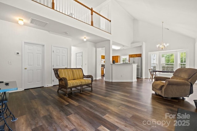 living area featuring a chandelier, high vaulted ceiling, visible vents, baseboards, and dark wood finished floors