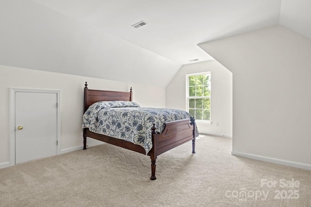 bedroom with baseboards, visible vents, carpet floors, and vaulted ceiling