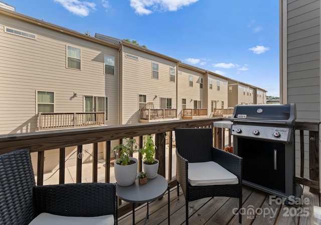wooden deck with a residential view and grilling area