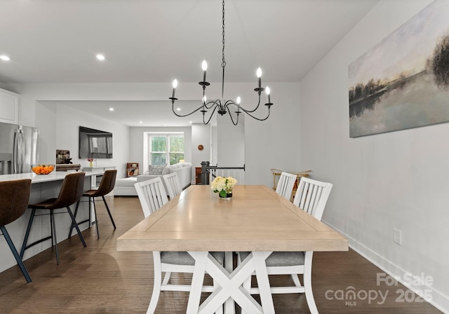 dining room with wood finished floors, recessed lighting, and a chandelier