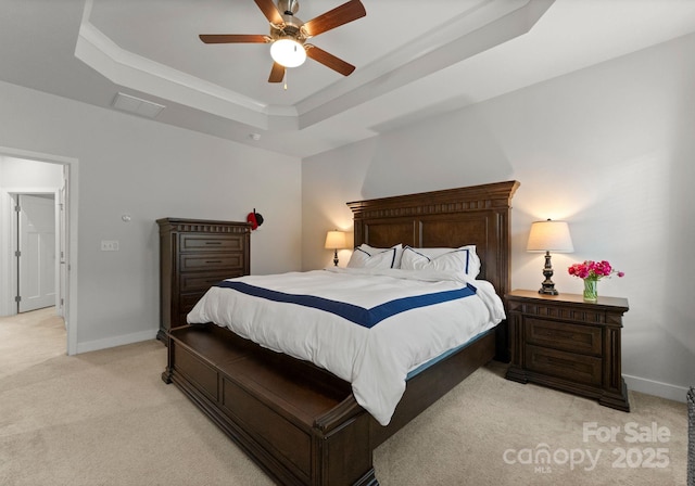 bedroom with light colored carpet, visible vents, a ceiling fan, a raised ceiling, and baseboards