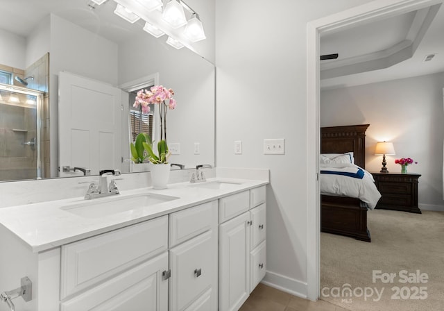 ensuite bathroom featuring a sink, double vanity, ensuite bathroom, and an enclosed shower