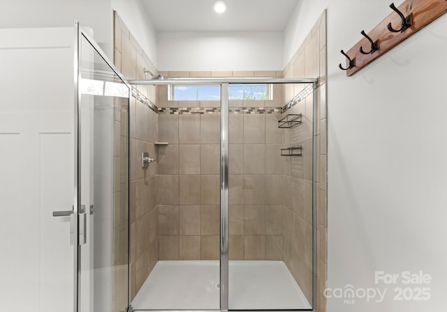 bathroom with a stall shower and recessed lighting