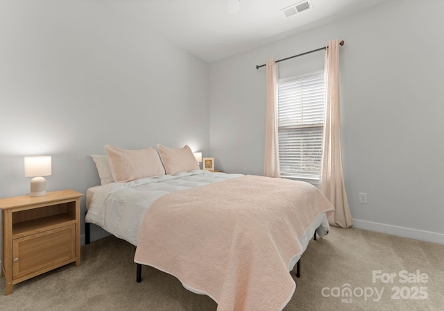 bedroom with light colored carpet, visible vents, and baseboards