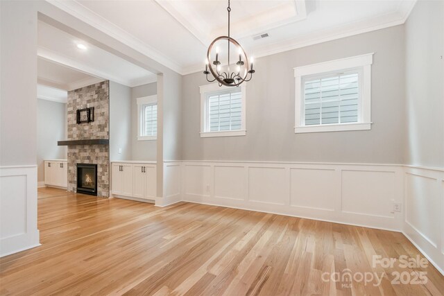 14119 Shelburne Village Dr, Charlotte, NC 28278 - unfurnished dining area featuring a chandelier, crown molding, visible vents, and light wood-style floors