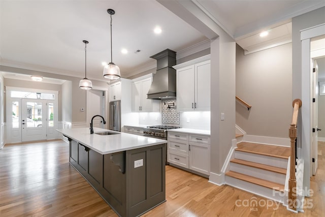 14119 Shelburne Village Dr, Charlotte, NC 28278 - kitchen with high end appliances, light countertops, white cabinets, ornamental molding, and premium range hood