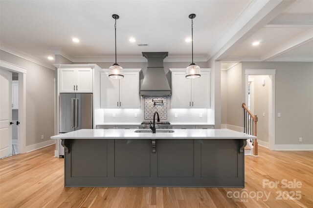 14119 Shelburne Village Dr, Charlotte, NC 28278 - kitchen featuring a sink, high end refrigerator, light countertops, premium range hood, and white cabinets