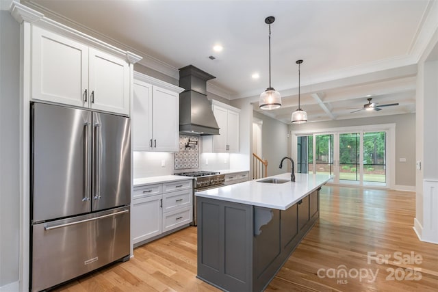 14119 Shelburne Village Dr, Charlotte, NC 28278 - kitchen featuring tasteful backsplash, light countertops, light wood finished floors, a sink, and premium appliances