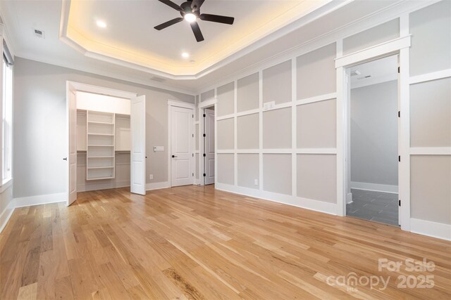 14119 Shelburne Village Dr, Charlotte, NC 28278 - unfurnished bedroom featuring visible vents, light wood-type flooring, baseboards, and a tray ceiling