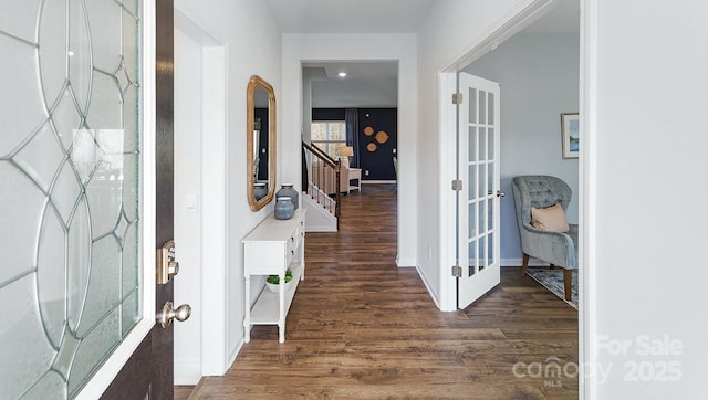 foyer featuring stairway, baseboards, french doors, and wood finished floors