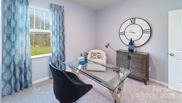 dining space featuring baseboards and carpet flooring