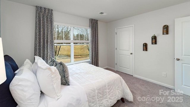 bedroom featuring baseboards, visible vents, and carpet