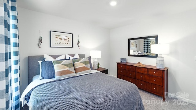 bedroom with baseboards and light carpet