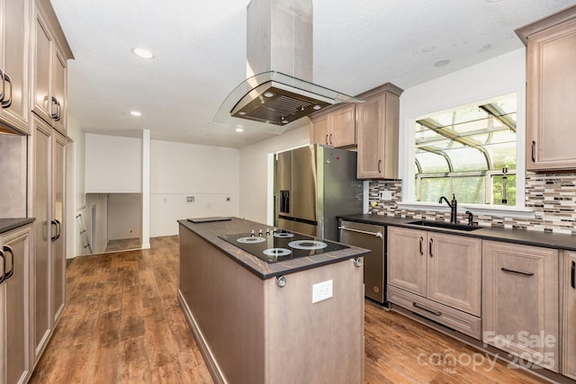 kitchen with a sink, dark countertops, stainless steel appliances, a center island, and island exhaust hood