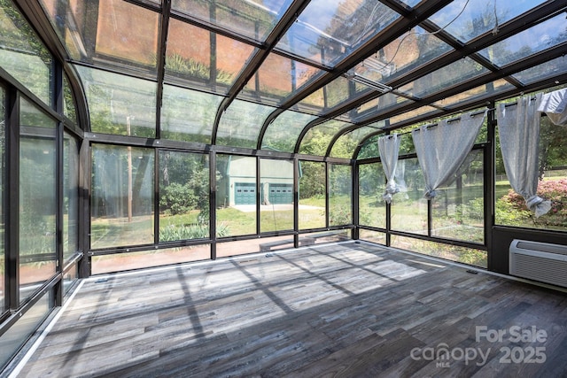 unfurnished sunroom featuring a wall mounted AC