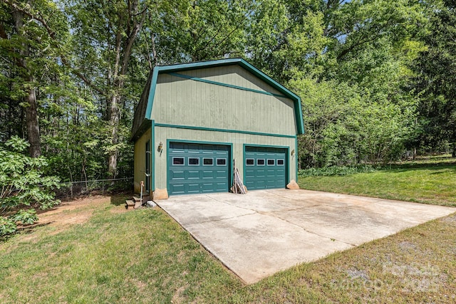 garage with fence and a detached garage