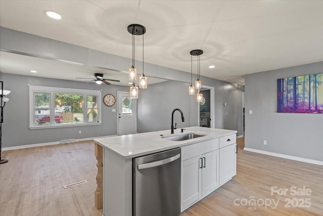 135 Mcshag Dr, Kannapolis, NC 28081 - kitchen with a sink, dishwasher, white cabinetry, open floor plan, and light wood-type flooring