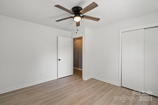 135 Mcshag Dr, Kannapolis, NC 28081 - unfurnished bedroom featuring a closet, a ceiling fan, light wood-style flooring, and baseboards