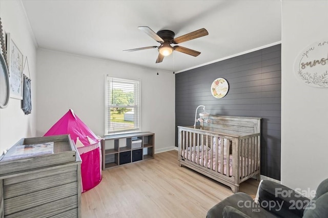 135 Mcshag Dr, Kannapolis, NC 28081 - bedroom featuring wood walls, ornamental molding, wood finished floors, baseboards, and ceiling fan