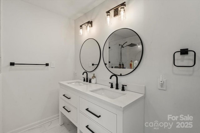 135 Mcshag Dr, Kannapolis, NC 28081 - bathroom featuring double vanity, baseboards, a sink, and marble finish floor