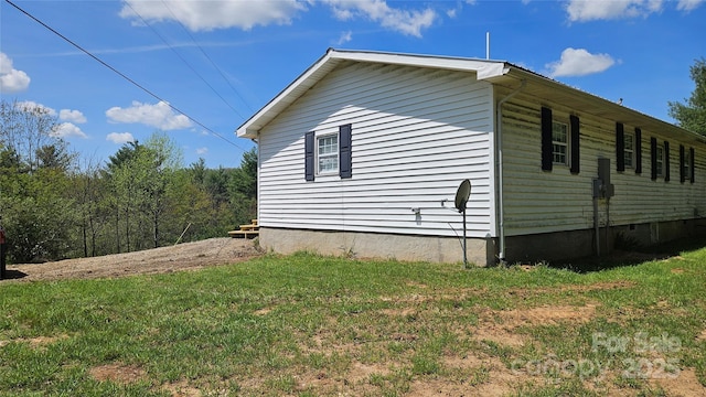 view of property exterior featuring a lawn