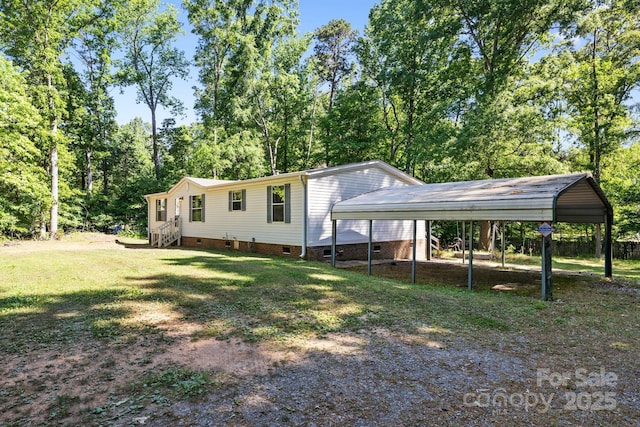 3317 Treyburn Dr, Midland, NC 28107 - back of property with a lawn, driveway, crawl space, and a carport