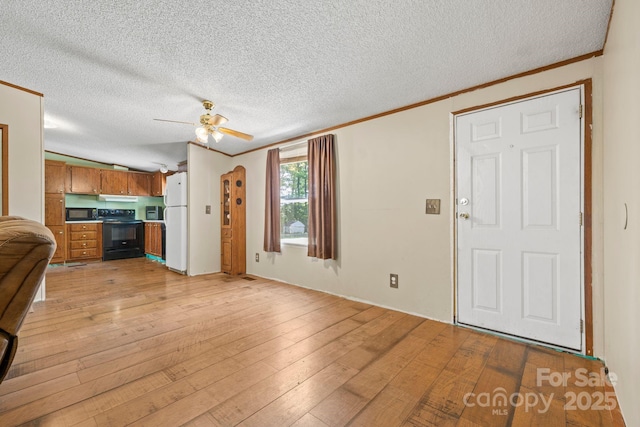 3317 Treyburn Dr, Midland, NC 28107 - unfurnished living room featuring a ceiling fan, a textured ceiling, ornamental molding, and light wood-type flooring