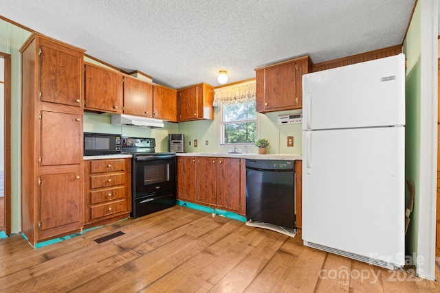 3317 Treyburn Dr, Midland, NC 28107 - kitchen featuring brown cabinets, visible vents, black appliances, and light wood-type flooring