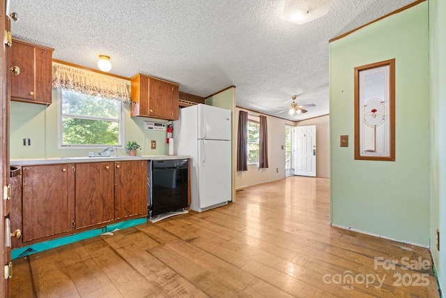 3317 Treyburn Dr, Midland, NC 28107 - kitchen with freestanding refrigerator, dishwasher, brown cabinets, and light countertops