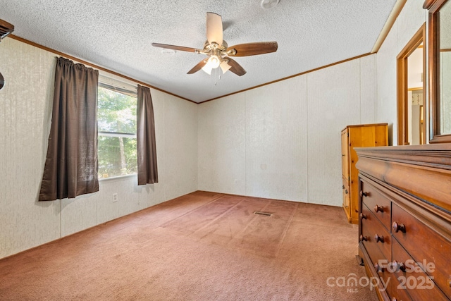 3317 Treyburn Dr, Midland, NC 28107 - empty room with crown molding, a ceiling fan, a textured ceiling, and light colored carpet